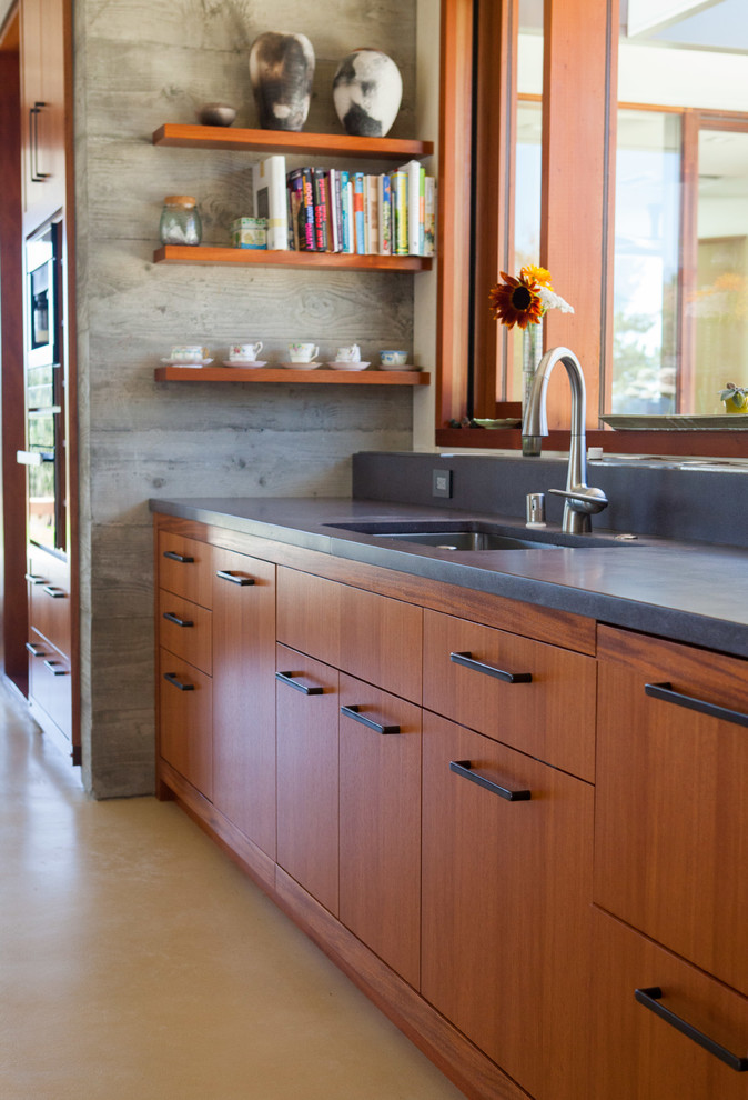 サンフランシスコにある広いアジアンスタイルのおしゃれなアイランドキッチン (コンクリートカウンター、シルバーの調理設備、コンクリートの床) の写真