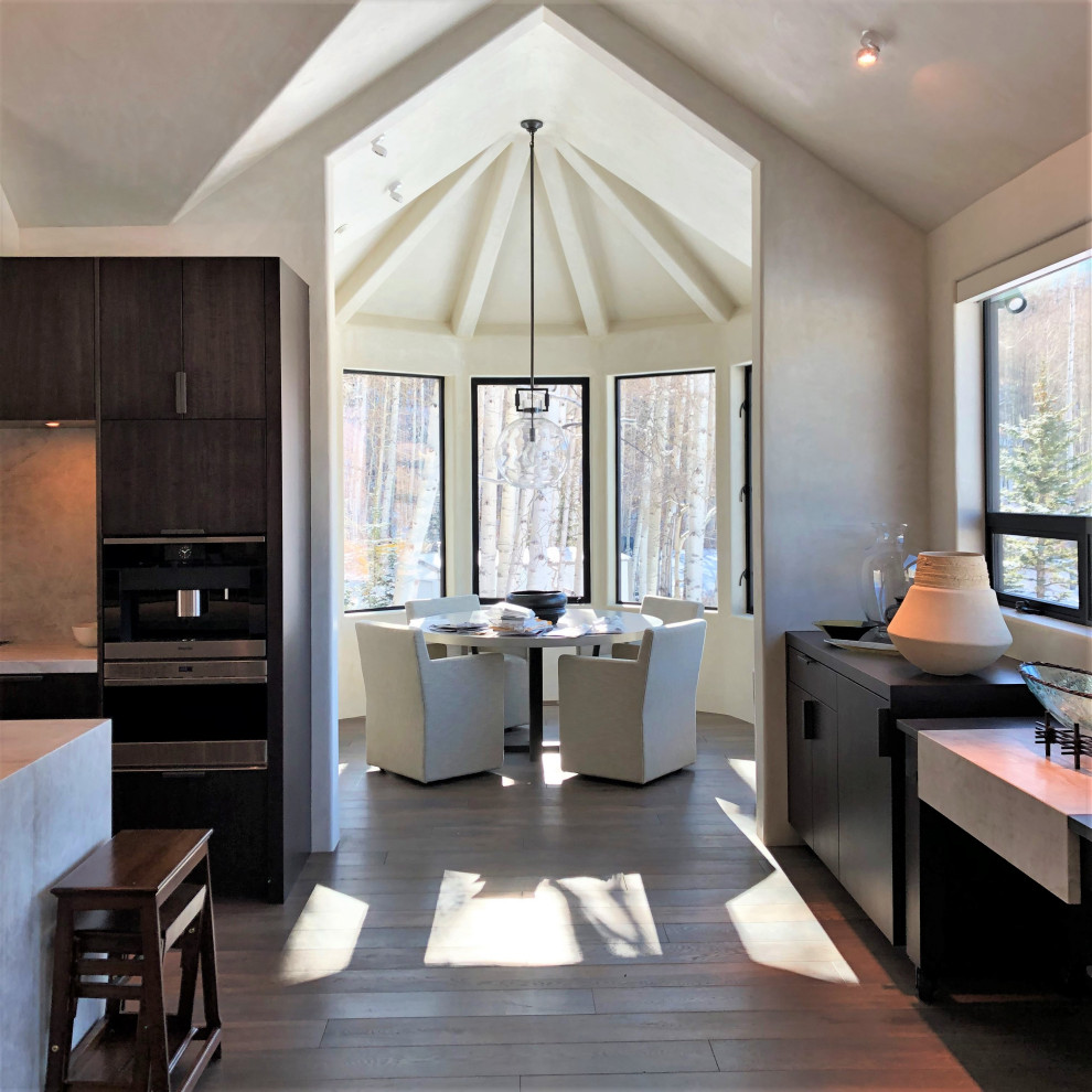 Large trendy galley medium tone wood floor, brown floor and vaulted ceiling open concept kitchen photo in Other with an undermount sink, flat-panel cabinets, dark wood cabinets, multicolored backsplash, colored appliances, an island and multicolored countertops
