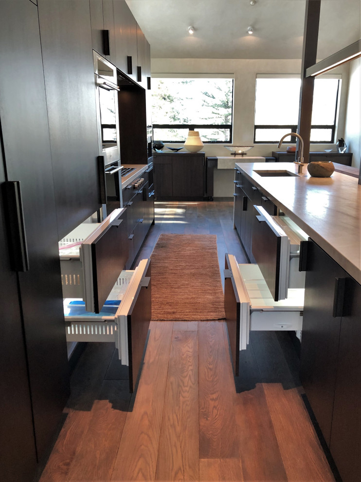 Open concept kitchen - large contemporary galley medium tone wood floor, brown floor and vaulted ceiling open concept kitchen idea in Other with an undermount sink, flat-panel cabinets, dark wood cabinets, colored appliances, an island and multicolored countertops