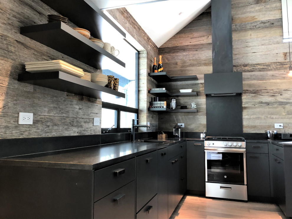 Inspiration for a mid-sized contemporary u-shaped light wood floor, orange floor and vaulted ceiling open concept kitchen remodel in Other with an undermount sink, flat-panel cabinets, black cabinets, brown backsplash, stainless steel appliances, a peninsula and brown countertops