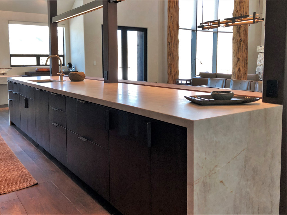 Example of a large trendy galley medium tone wood floor, brown floor and vaulted ceiling open concept kitchen design in Other with an undermount sink, flat-panel cabinets, dark wood cabinets, colored appliances, an island and multicolored countertops