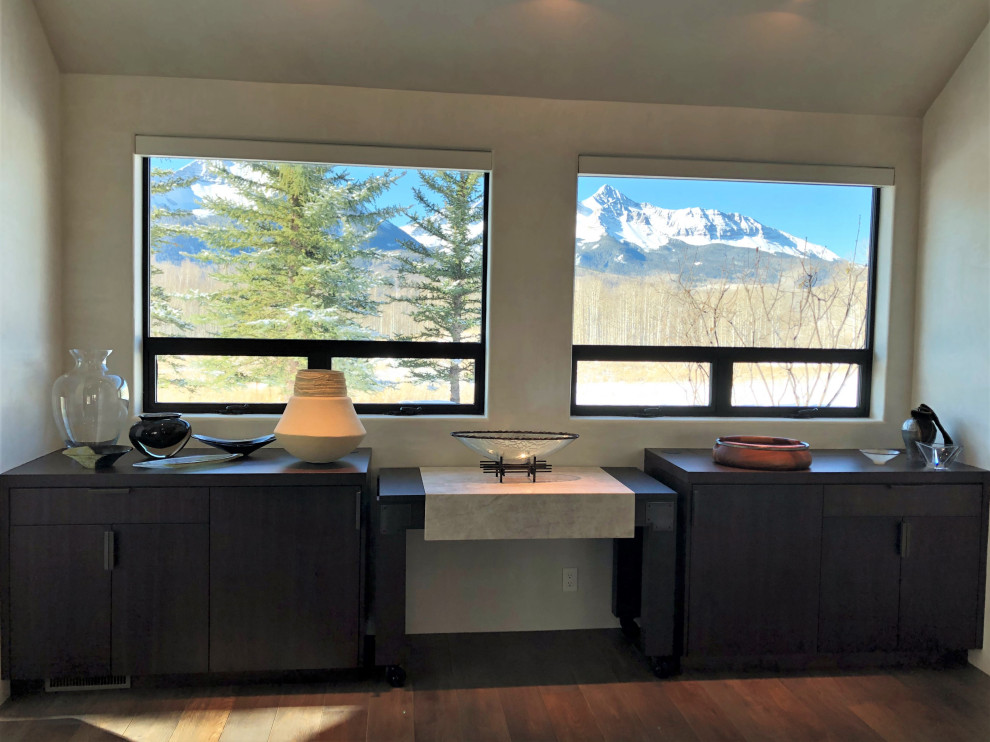Large trendy galley medium tone wood floor, brown floor and vaulted ceiling open concept kitchen photo in Other with an undermount sink, flat-panel cabinets, dark wood cabinets, colored appliances, an island and multicolored countertops