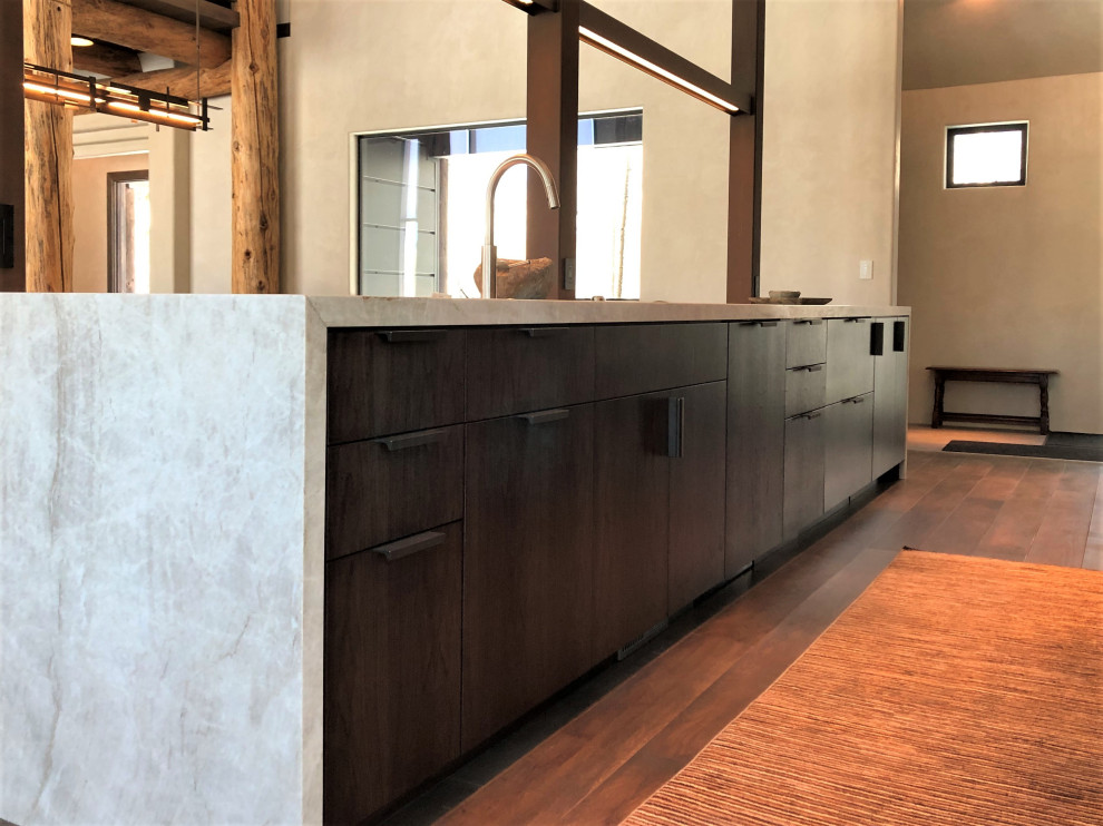 Example of a large trendy galley medium tone wood floor, brown floor and vaulted ceiling open concept kitchen design in Other with an undermount sink, flat-panel cabinets, dark wood cabinets, colored appliances, an island and multicolored countertops