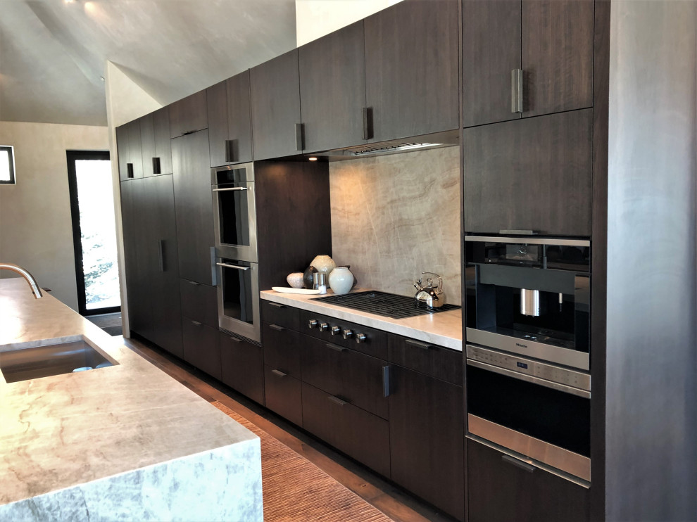Example of a large trendy galley medium tone wood floor, brown floor and vaulted ceiling open concept kitchen design in Other with an undermount sink, flat-panel cabinets, dark wood cabinets, colored appliances, an island and multicolored countertops