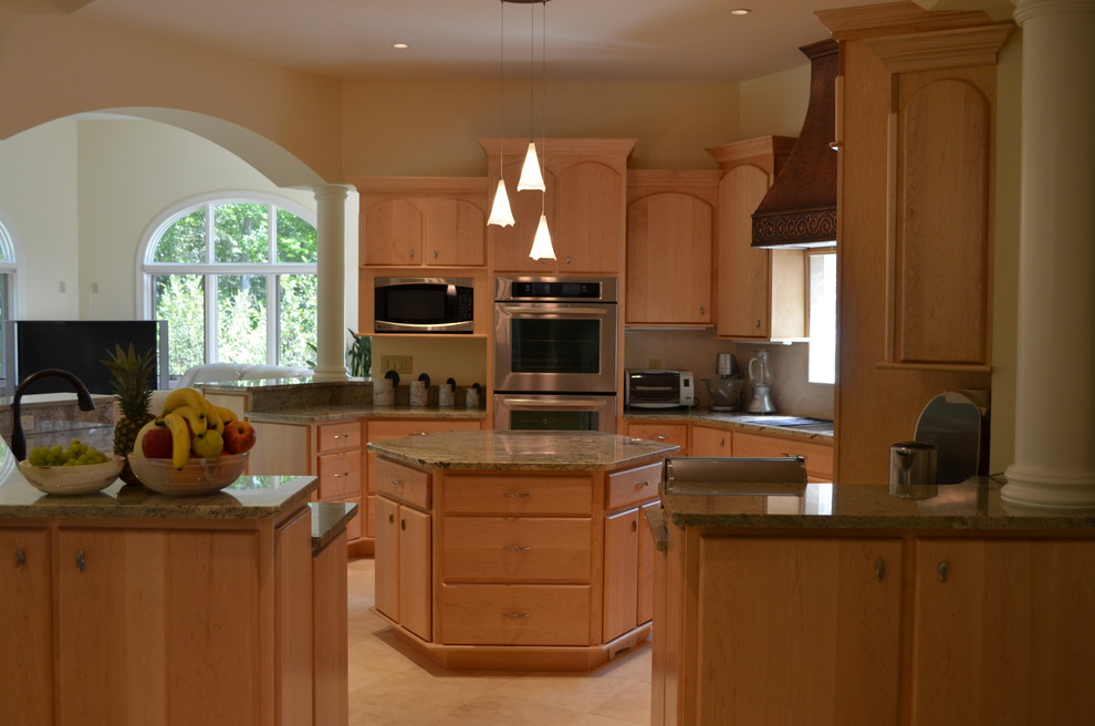 Пример оригинального дизайна: п-образная кухня-гостиная среднего размера в современном стиле с плоскими фасадами, светлыми деревянными фасадами, гранитной столешницей, техникой из нержавеющей стали, полом из керамогранита и островом