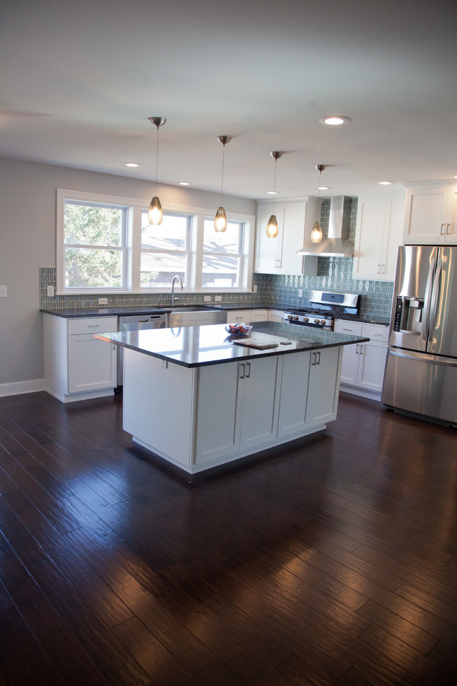 Example of a mid-sized transitional dark wood floor eat-in kitchen design in Minneapolis with an undermount sink, shaker cabinets, white cabinets, granite countertops, blue backsplash, glass tile backsplash, stainless steel appliances and an island