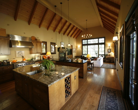 Photo of a large rustic u-shaped open plan kitchen in Sacramento with a submerged sink, shaker cabinets, light wood cabinets, granite worktops, beige splashback, stone tiled splashback, stainless steel appliances, light hardwood flooring and an island.