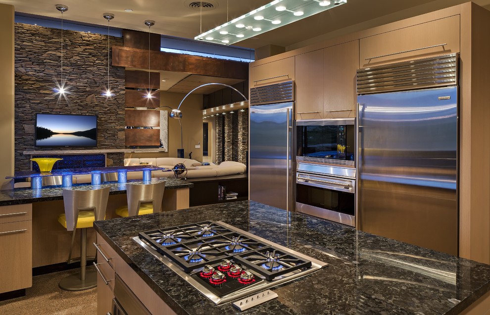 Example of a large trendy concrete floor open concept kitchen design in Phoenix with flat-panel cabinets, light wood cabinets, granite countertops, gray backsplash, stone slab backsplash, stainless steel appliances and an island