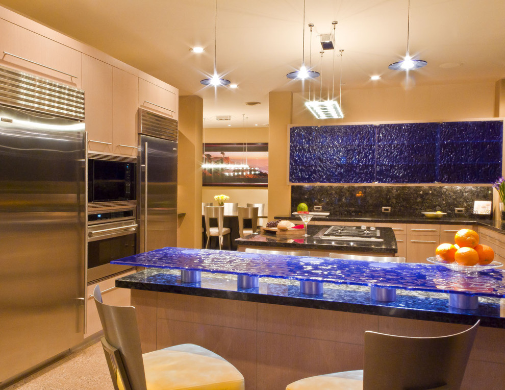 Large trendy concrete floor and beige floor eat-in kitchen photo in Phoenix with glass-front cabinets, glass countertops, black backsplash, glass tile backsplash, stainless steel appliances, two islands and blue countertops