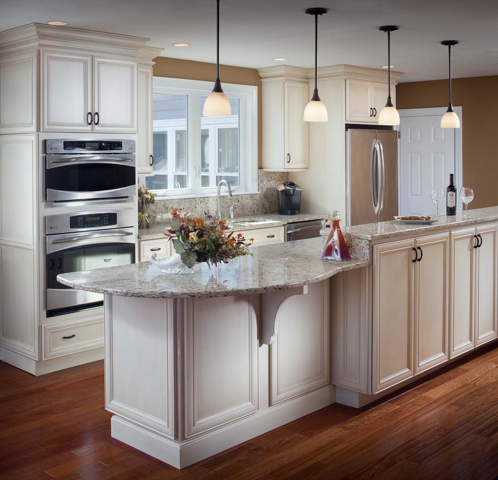 Design ideas for a classic galley kitchen in San Diego with a submerged sink, granite worktops, recessed-panel cabinets, white cabinets, multi-coloured splashback, stone slab splashback and stainless steel appliances.