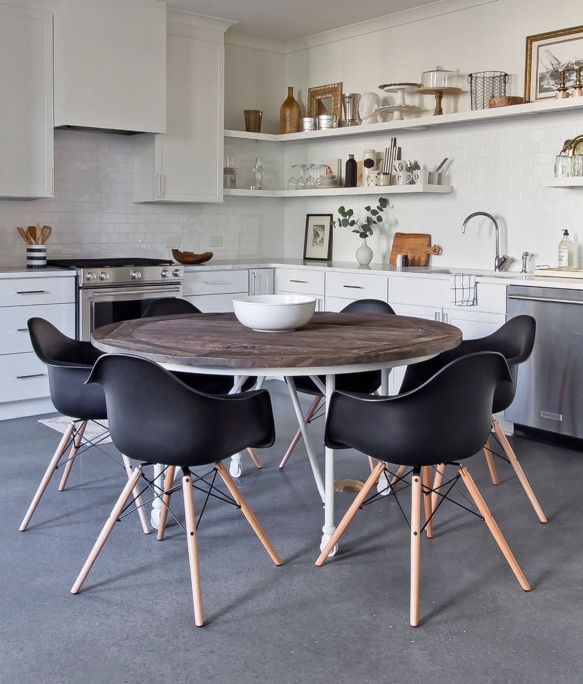 Small danish l-shaped concrete floor eat-in kitchen photo in Atlanta with an undermount sink, flat-panel cabinets, white cabinets, marble countertops, white backsplash, ceramic backsplash, stainless steel appliances and no island