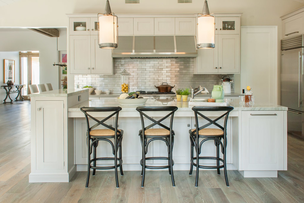 Large elegant l-shaped medium tone wood floor eat-in kitchen photo in San Diego with a farmhouse sink, recessed-panel cabinets, gray cabinets, quartzite countertops, metallic backsplash, metal backsplash and stainless steel appliances