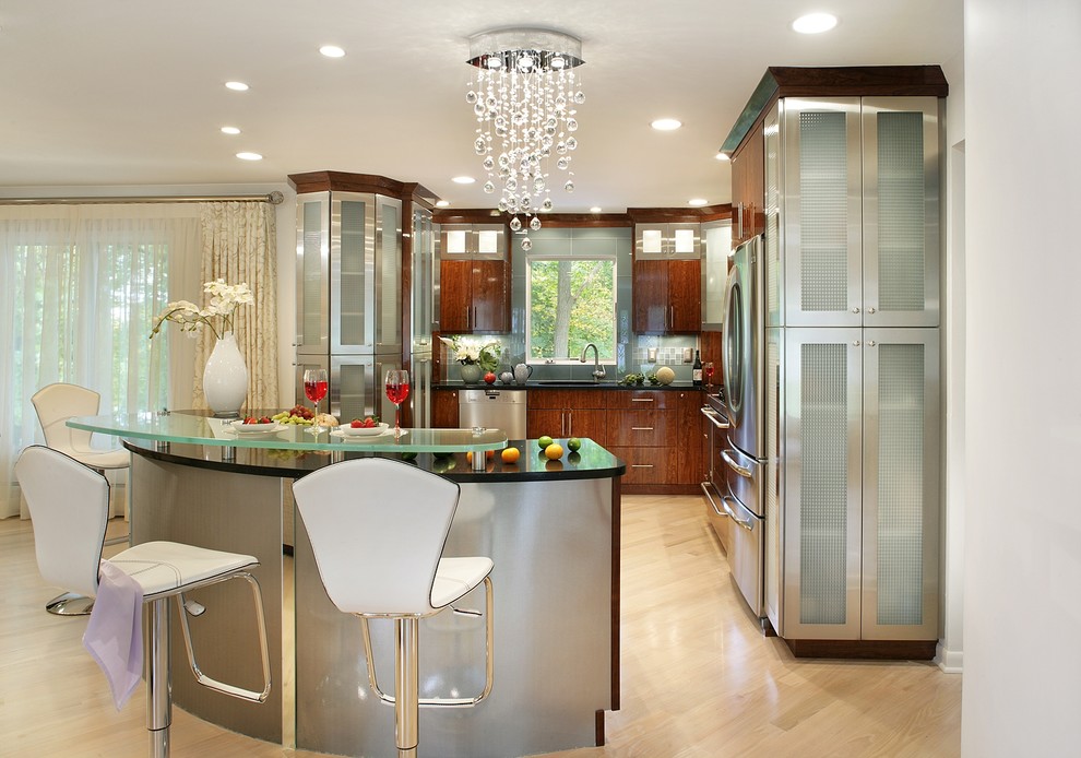 Example of a large minimalist l-shaped light wood floor eat-in kitchen design in New York with an undermount sink, flat-panel cabinets, stainless steel cabinets, solid surface countertops, blue backsplash, glass tile backsplash, stainless steel appliances and an island