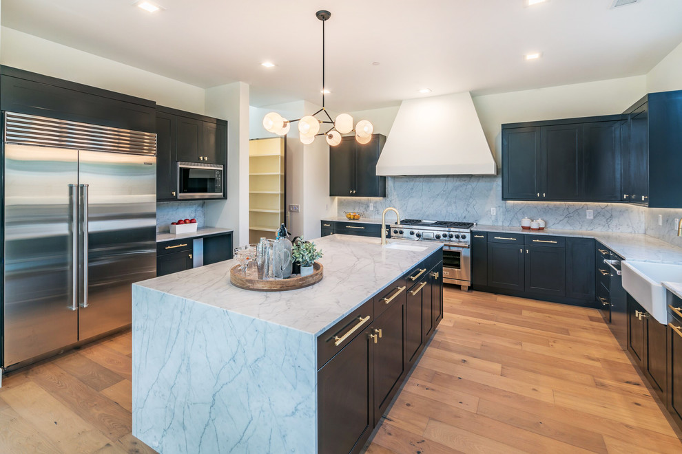 Inredning av ett modernt mellanstort flerfärgad flerfärgat kök, med en undermonterad diskho, skåp i shakerstil, svarta skåp, marmorbänkskiva, flerfärgad stänkskydd, stänkskydd i marmor, rostfria vitvaror, mellanmörkt trägolv, en köksö och brunt golv