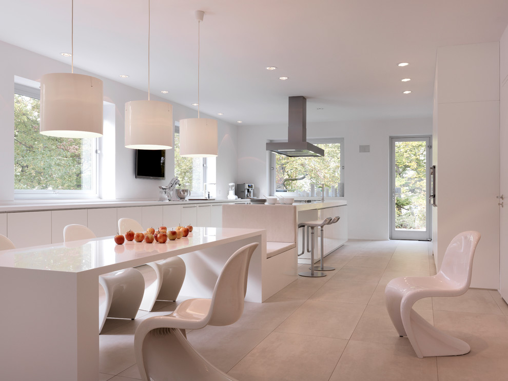 Photo of a large contemporary galley kitchen/diner in Other with flat-panel cabinets, white cabinets and an island.
