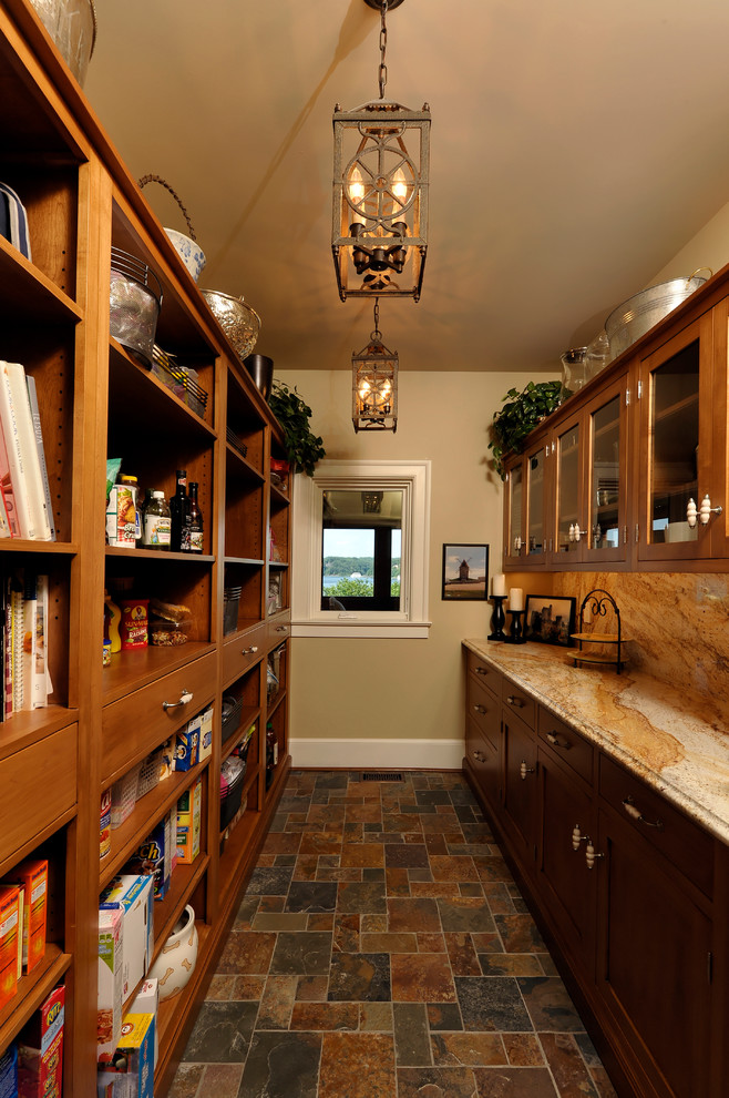 This is an example of a medium sized eclectic galley kitchen pantry in Baltimore with shaker cabinets, medium wood cabinets, granite worktops, beige splashback, stone slab splashback and slate flooring.
