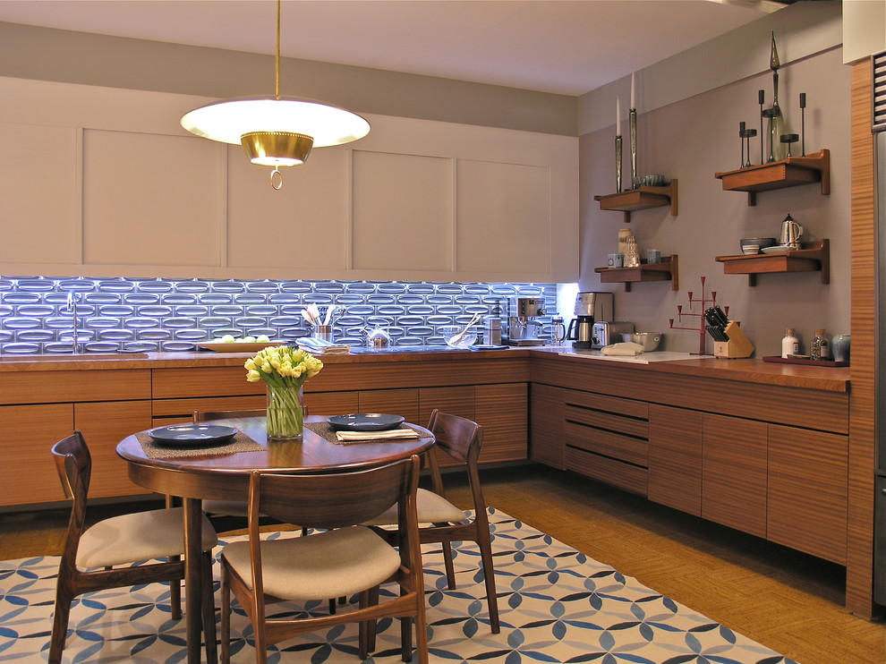 Example of a trendy l-shaped enclosed kitchen design in New York with an undermount sink, flat-panel cabinets, white cabinets, wood countertops, metallic backsplash, ceramic backsplash and stainless steel appliances