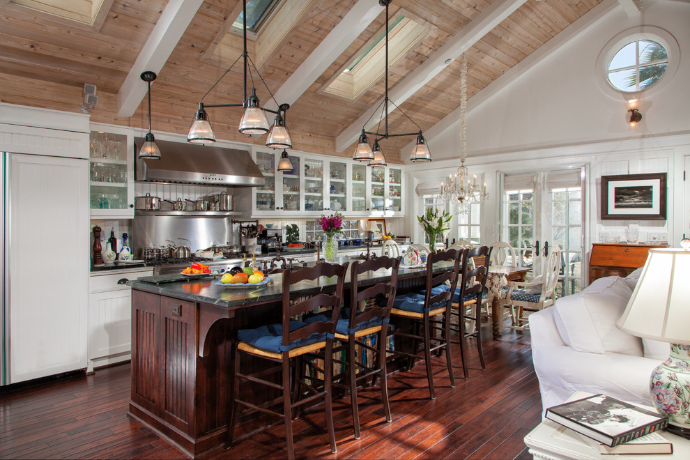 Inspiration for a traditional galley open plan kitchen in San Diego with beaded cabinets, soapstone worktops, stainless steel appliances, medium hardwood flooring and an island.