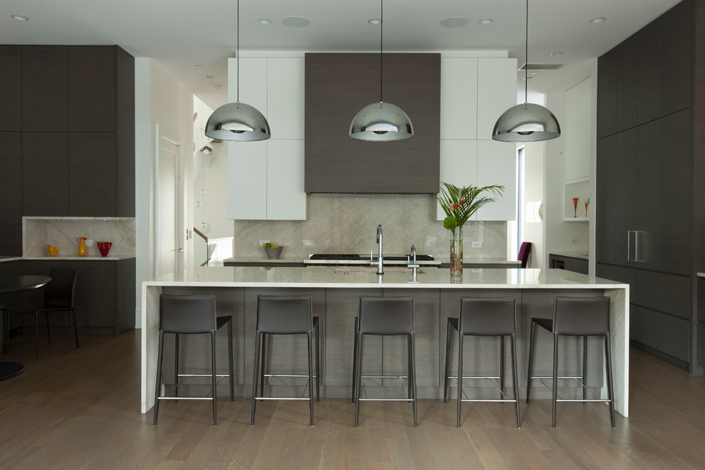 Inspiration for a contemporary kitchen in Chicago with a submerged sink, flat-panel cabinets, white cabinets, grey splashback, stone slab splashback, dark hardwood flooring, an island and brown floors.