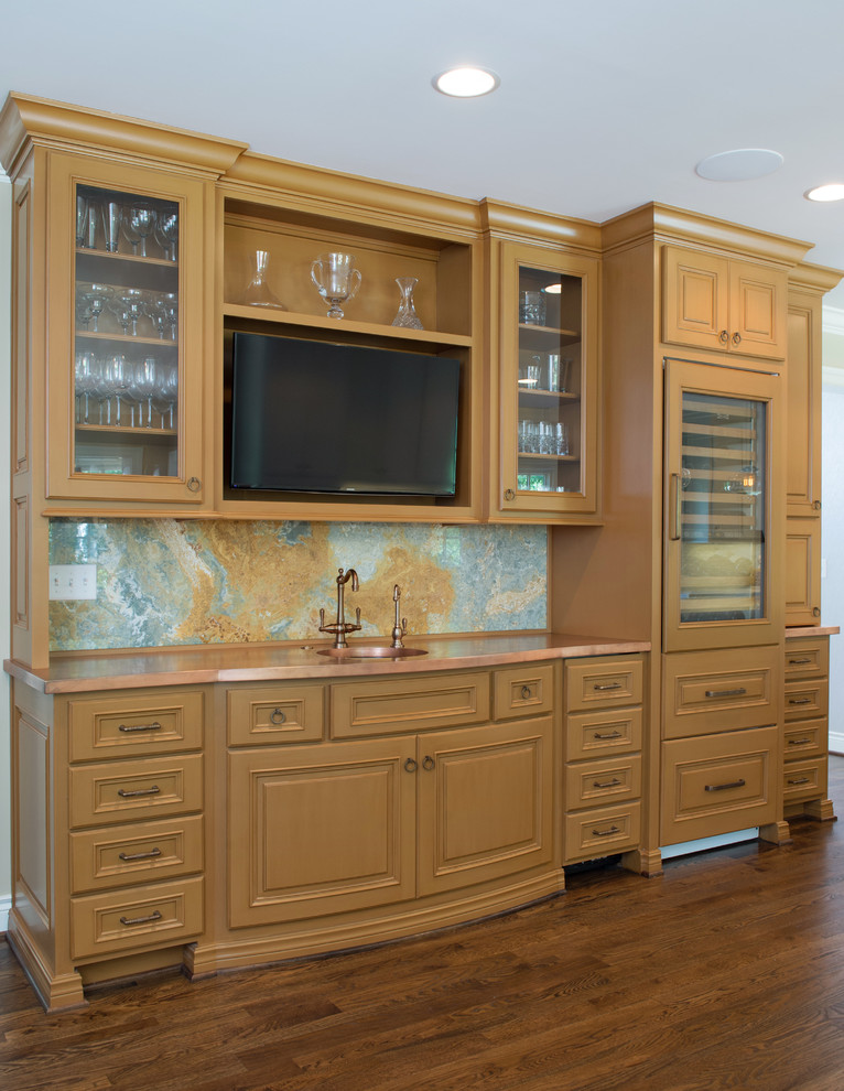 This is an example of a medium sized traditional kitchen/diner in Kansas City with raised-panel cabinets, brown cabinets, copper worktops, blue splashback, stone slab splashback, medium hardwood flooring and an island.
