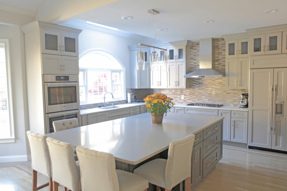 Eat-in kitchen - huge craftsman light wood floor eat-in kitchen idea in Providence with a single-bowl sink, shaker cabinets, gray cabinets, quartzite countertops, gray backsplash, stone tile backsplash and stainless steel appliances