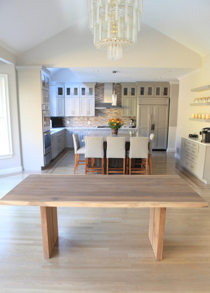 Inspiration for a huge craftsman light wood floor eat-in kitchen remodel in Providence with a single-bowl sink, shaker cabinets, gray cabinets, quartzite countertops, gray backsplash, stone tile backsplash and stainless steel appliances