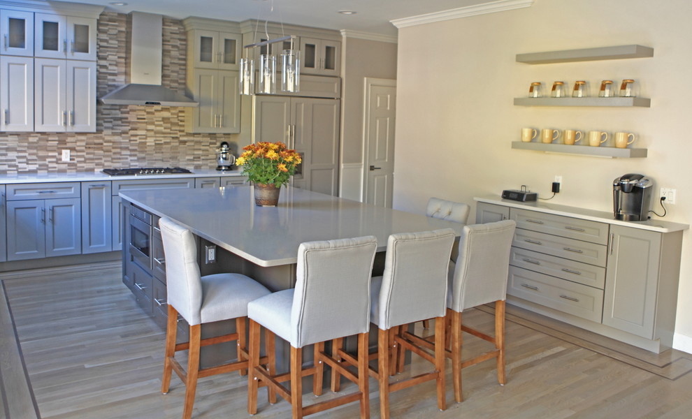 Inspiration for a huge craftsman light wood floor eat-in kitchen remodel in Providence with a single-bowl sink, shaker cabinets, gray cabinets, quartzite countertops, gray backsplash, stone tile backsplash and stainless steel appliances