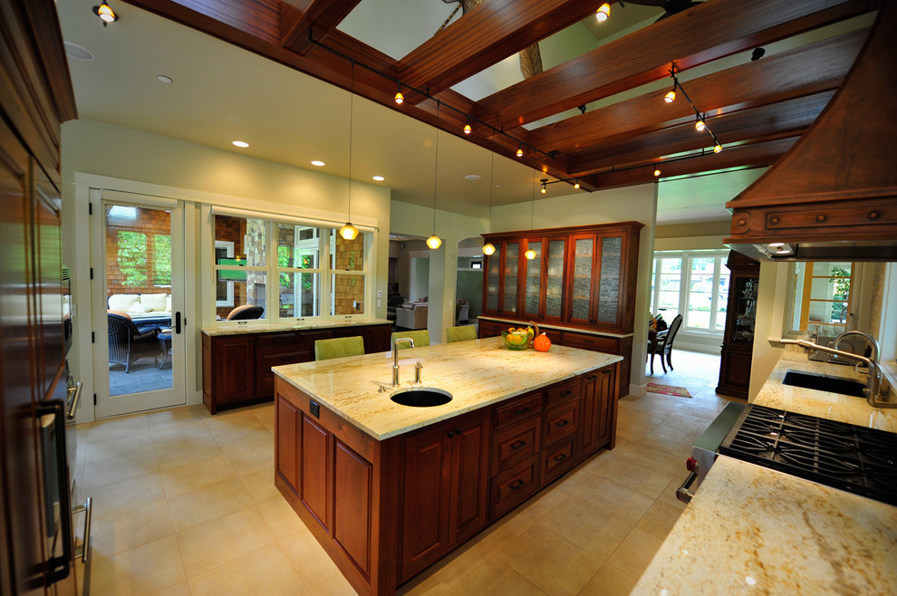 Photo of an expansive classic kitchen in Portland with a submerged sink, raised-panel cabinets, dark wood cabinets, granite worktops, stainless steel appliances, ceramic flooring and an island.