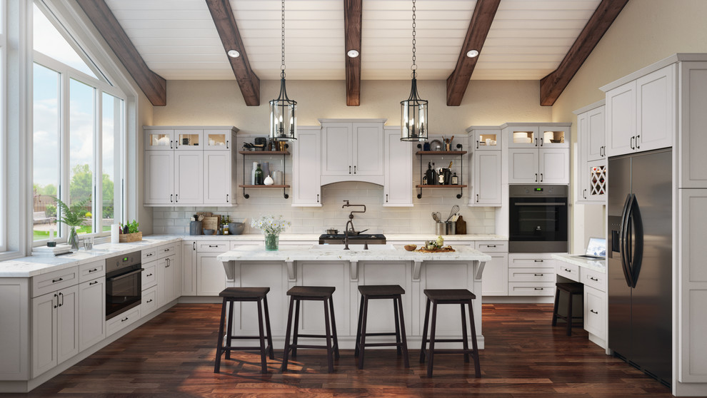 Example of a huge minimalist u-shaped laminate floor and brown floor eat-in kitchen design with a farmhouse sink, shaker cabinets, white cabinets, granite countertops, white backsplash, subway tile backsplash, stainless steel appliances, an island and white countertops