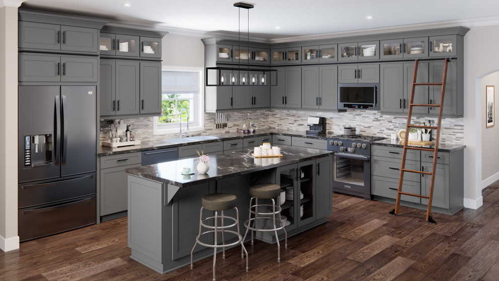 Inspiration for an expansive contemporary l-shaped kitchen/diner with a double-bowl sink, shaker cabinets, grey cabinets, granite worktops, grey splashback, glass sheet splashback, stainless steel appliances, medium hardwood flooring, an island, brown floors and grey worktops.