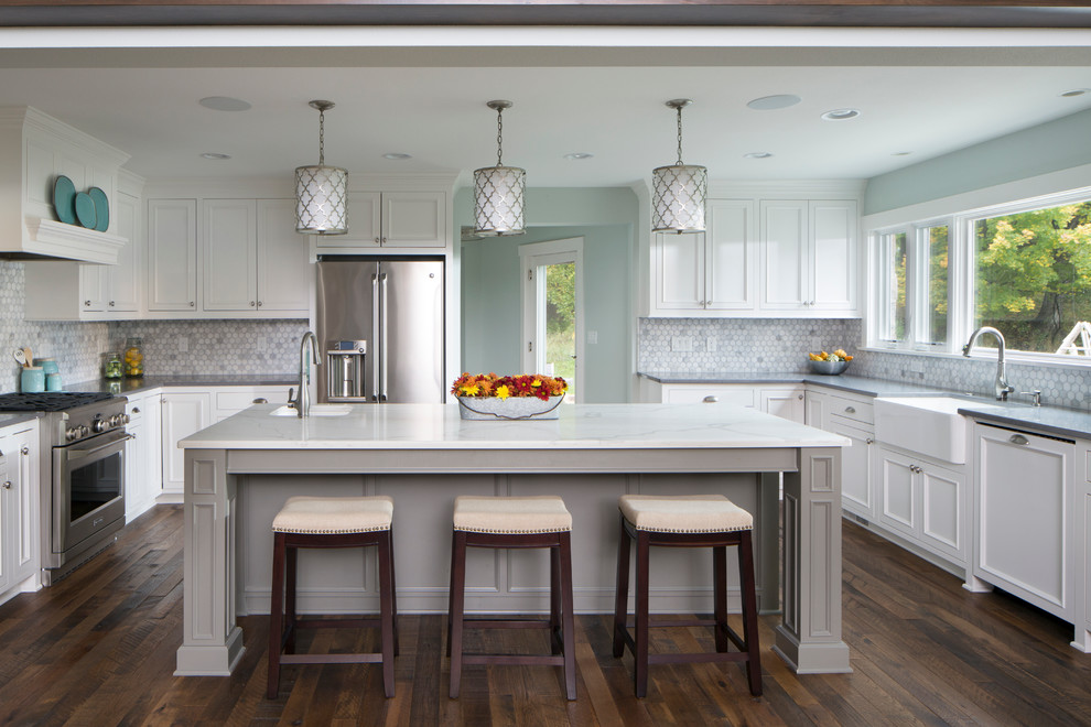 Inspiration for a large transitional u-shaped medium tone wood floor open concept kitchen remodel in Milwaukee with a farmhouse sink, flat-panel cabinets, white cabinets, quartz countertops, gray backsplash, ceramic backsplash, stainless steel appliances and an island
