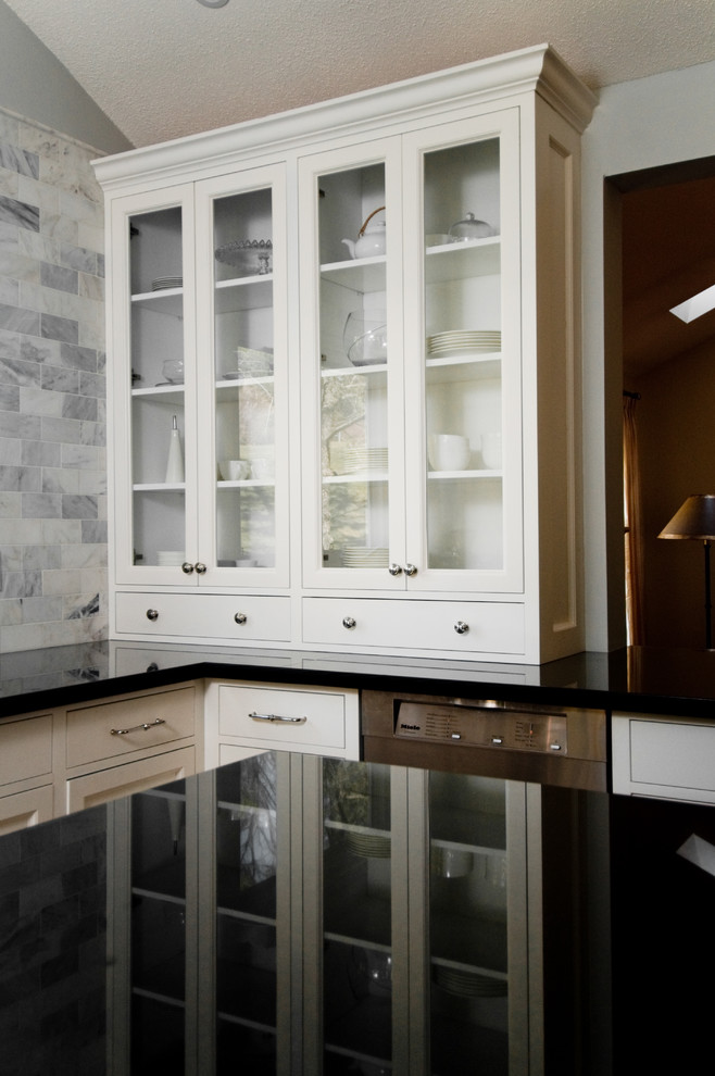 Inspiration for a timeless kitchen remodel in Toronto with glass-front cabinets, white cabinets, white backsplash, stainless steel appliances, granite countertops and marble backsplash