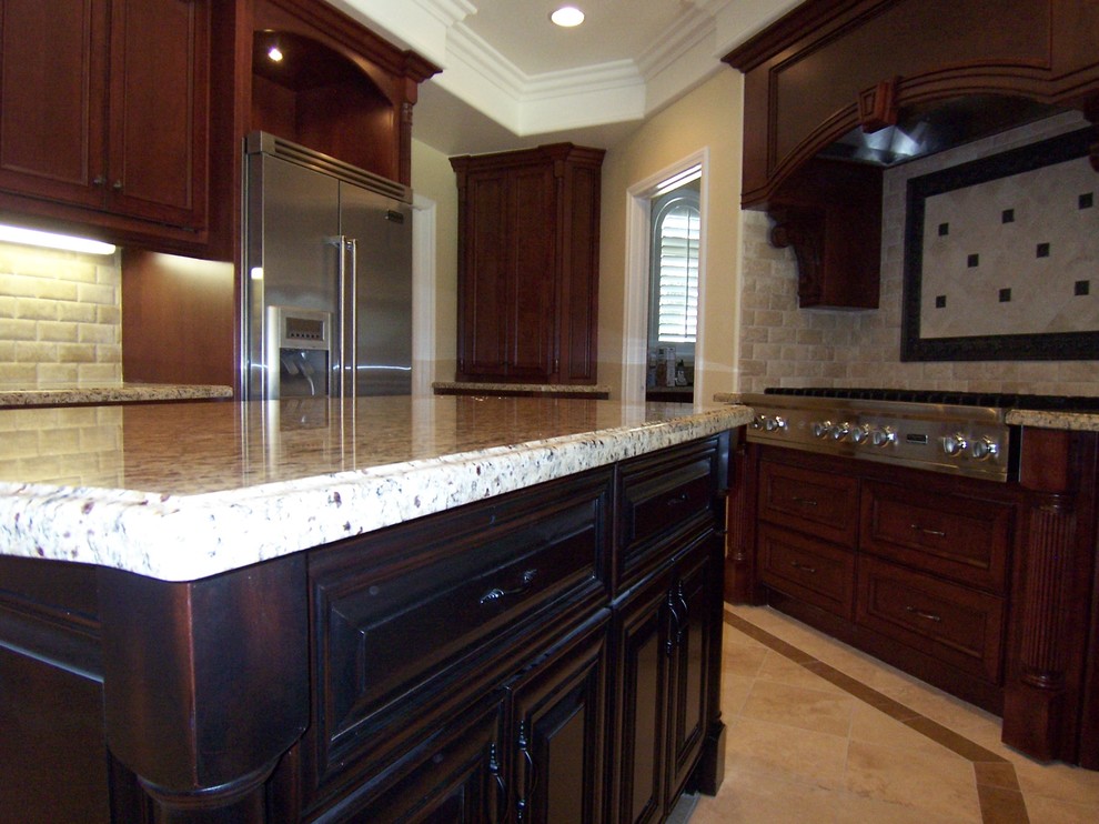 Photo of a medium sized traditional galley kitchen/diner in Orange County with raised-panel cabinets and an island.
