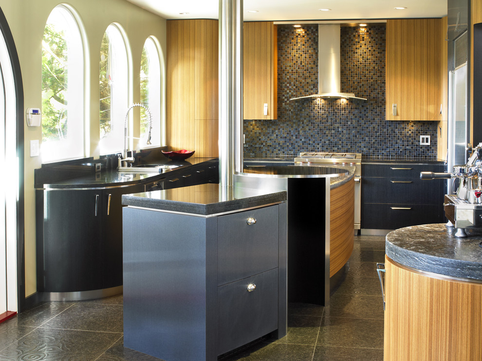 This is an example of a contemporary kitchen in Vancouver with mosaic tiled splashback, blue splashback, flat-panel cabinets and medium wood cabinets.