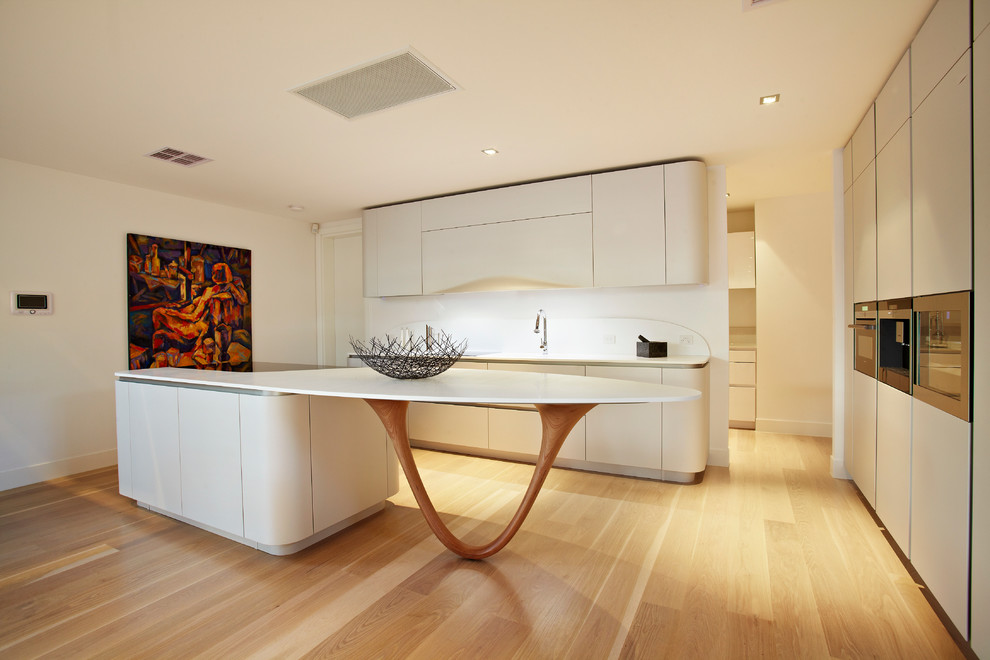 Trendy u-shaped open concept kitchen photo in Melbourne with flat-panel cabinets, white cabinets, solid surface countertops, white backsplash and stone slab backsplash