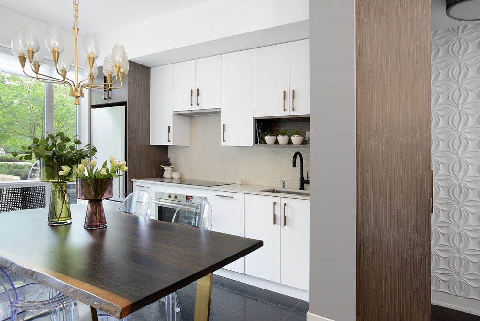 Eat-in kitchen - small modern galley black floor eat-in kitchen idea in Toronto with an undermount sink, flat-panel cabinets, white cabinets, stainless steel appliances and no island