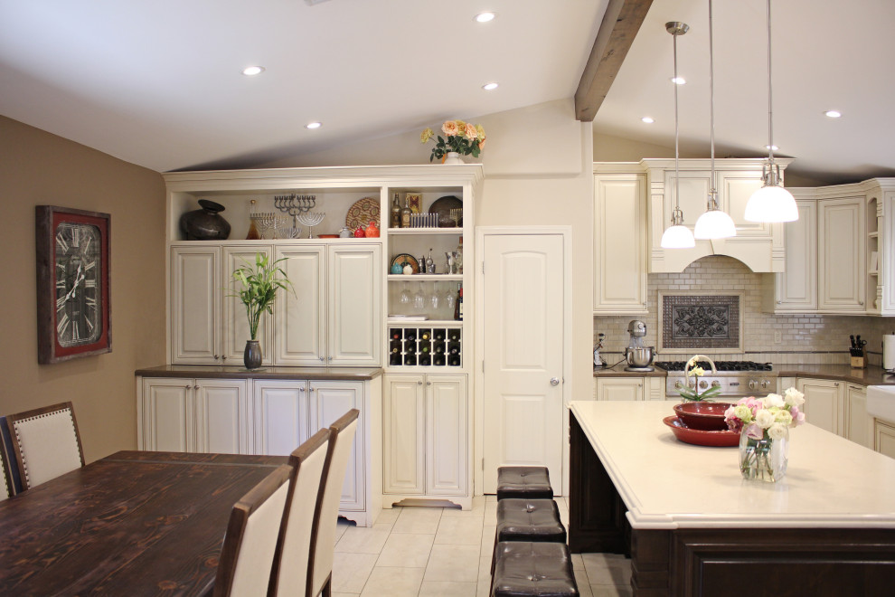Idéer för mellanstora vintage flerfärgat kök, med en rustik diskho, luckor med upphöjd panel, vita skåp, bänkskiva i kvartsit, beige stänkskydd, stänkskydd i marmor, rostfria vitvaror, klinkergolv i porslin, en köksö och beiget golv