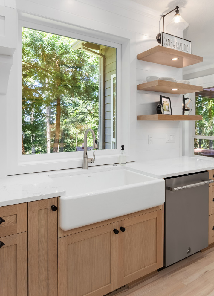 Large cottage l-shaped light wood floor eat-in kitchen photo in Portland with a farmhouse sink, shaker cabinets, light wood cabinets, quartz countertops, white backsplash, cement tile backsplash, stainless steel appliances, two islands and white countertops