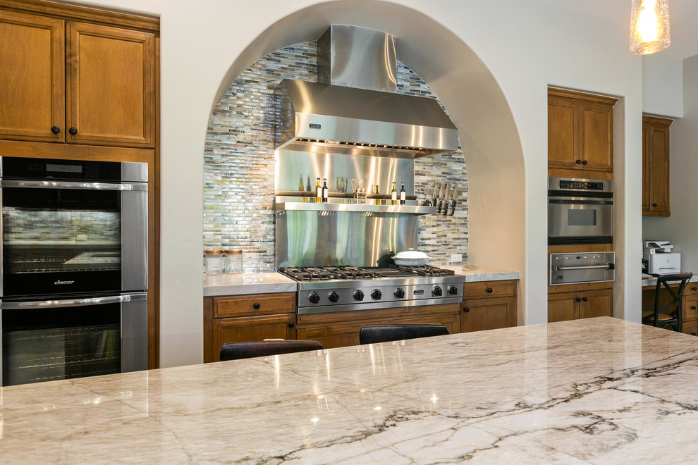 Kitchen - large transitional u-shaped travertine floor and brown floor kitchen idea in San Diego with an undermount sink, recessed-panel cabinets, medium tone wood cabinets, quartzite countertops, multicolored backsplash, stainless steel appliances, an island and gray countertops