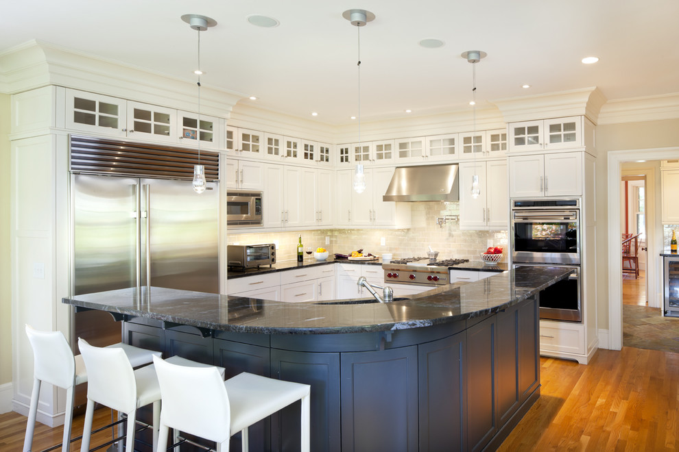 Ornate kitchen photo in Boston with stainless steel appliances, glass-front cabinets and white cabinets