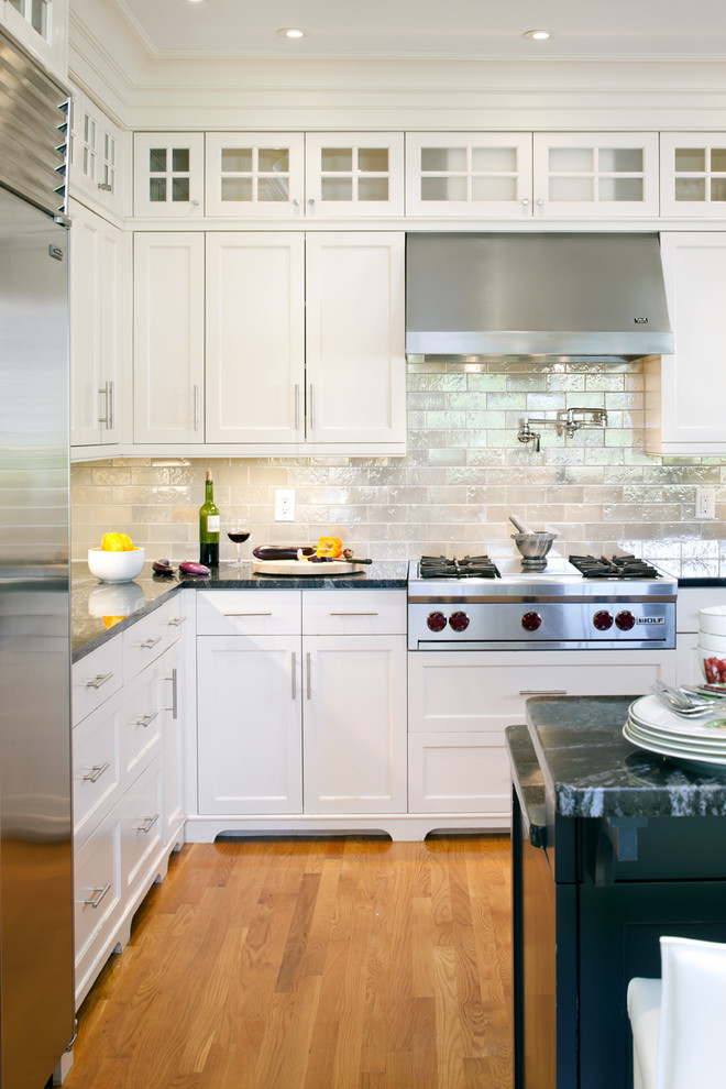 Inspiration for a victorian kitchen remodel in Boston with recessed-panel cabinets, stainless steel appliances, white cabinets, metallic backsplash and subway tile backsplash