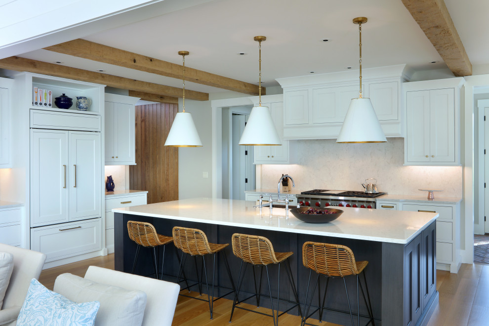 Example of a huge transitional l-shaped light wood floor and brown floor open concept kitchen design in Grand Rapids with a farmhouse sink, recessed-panel cabinets, white cabinets, granite countertops, white backsplash, granite backsplash, paneled appliances, an island and white countertops