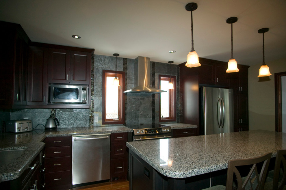 Eat-in kitchen - contemporary l-shaped dark wood floor eat-in kitchen idea in Other with a drop-in sink, beaded inset cabinets, dark wood cabinets, gray backsplash, stainless steel appliances, an island, granite countertops and stone tile backsplash