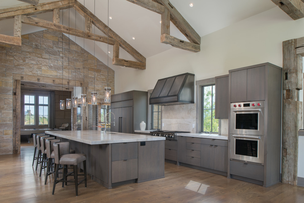 Rustic kitchen/diner in Other with flat-panel cabinets, quartz worktops, stone slab splashback, stainless steel appliances and an island.