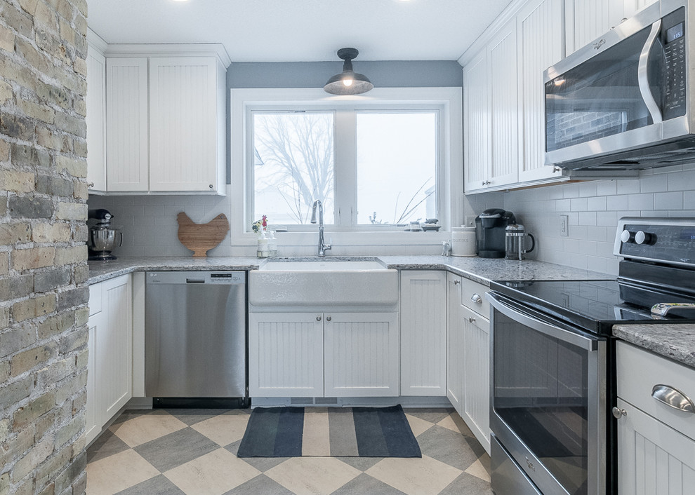 Small country u-shaped linoleum floor kitchen pantry photo in Minneapolis with a farmhouse sink, beaded inset cabinets, white cabinets, granite countertops, white backsplash, ceramic backsplash, stainless steel appliances and no island