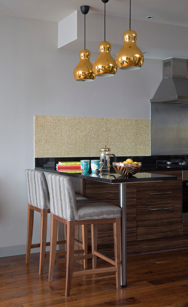 Contemporary kitchen in London with flat-panel cabinets, mosaic tiled splashback and a breakfast bar.