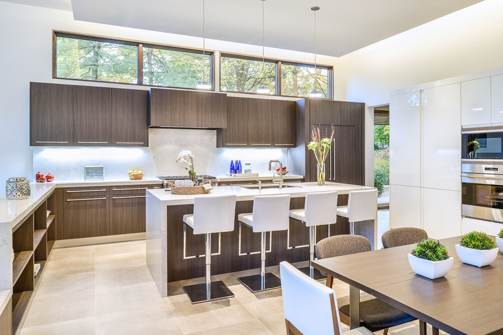 Example of a large minimalist u-shaped ceramic tile kitchen design in New York with a double-bowl sink, flat-panel cabinets, medium tone wood cabinets, solid surface countertops, white backsplash, stone slab backsplash, stainless steel appliances and an island
