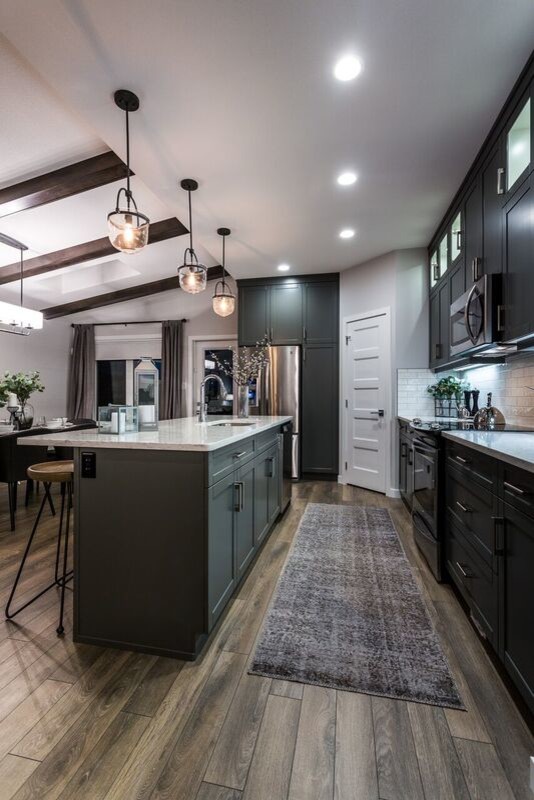 Eat-in kitchen - mid-sized modern galley laminate floor eat-in kitchen idea in Calgary with an undermount sink, shaker cabinets, gray cabinets, granite countertops, white backsplash, subway tile backsplash, stainless steel appliances and an island