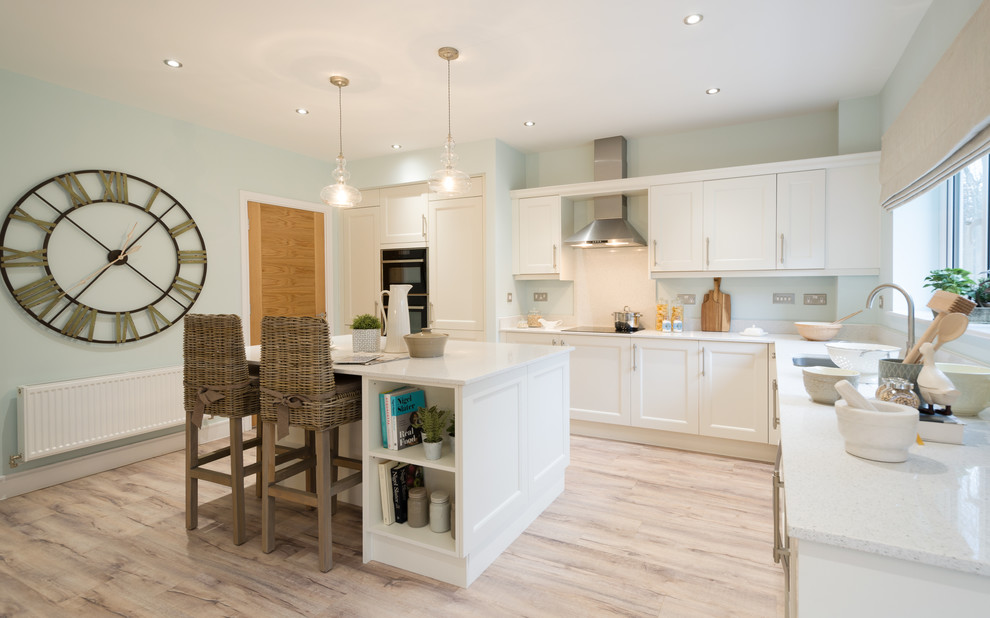 Medium sized coastal l-shaped kitchen/diner in Other with a built-in sink, shaker cabinets, white cabinets, composite countertops, white splashback, stone slab splashback, stainless steel appliances, travertine flooring, an island and beige floors.