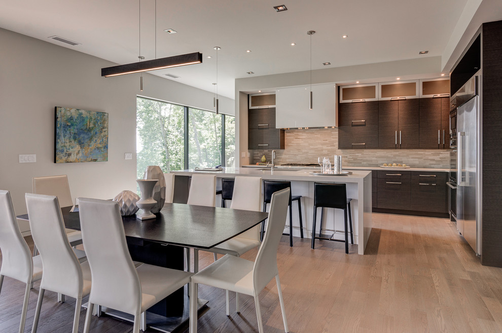 Open concept kitchen - large contemporary l-shaped light wood floor open concept kitchen idea in Other with a single-bowl sink, flat-panel cabinets, dark wood cabinets, quartz countertops, multicolored backsplash, mosaic tile backsplash, stainless steel appliances and an island